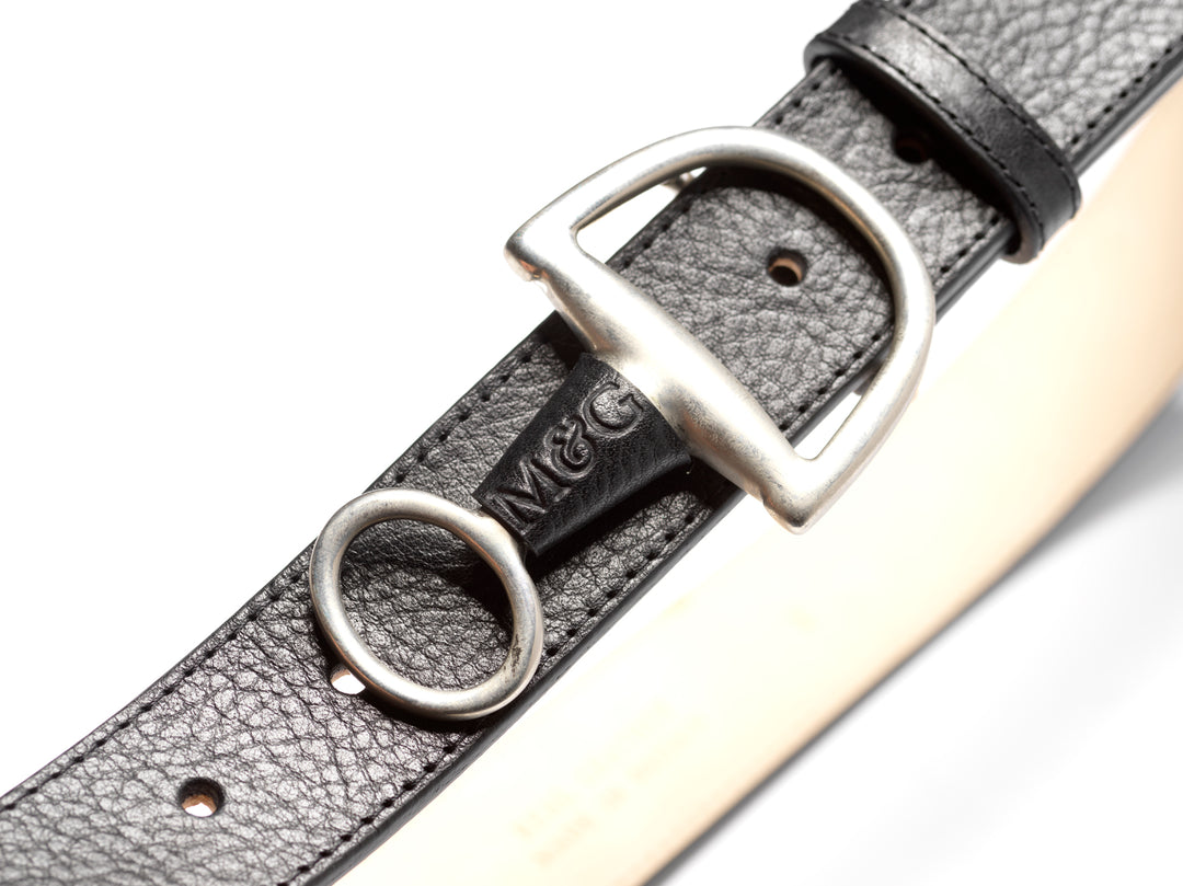 Close-up of a black Windsor belt with silver-tone fittings
