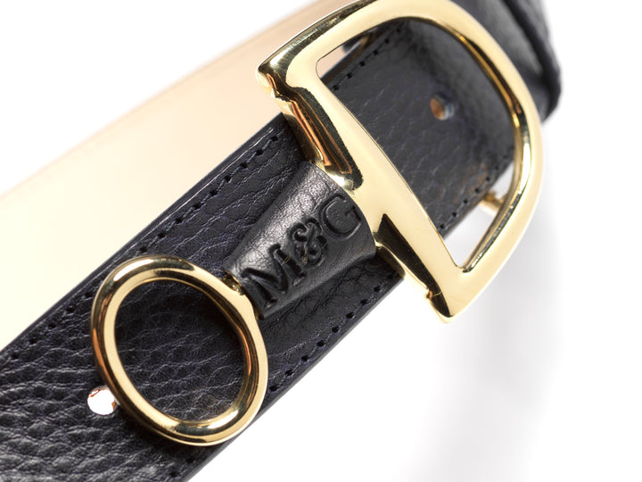 Close-up of a dark Windsor belt with gold-tone fittings