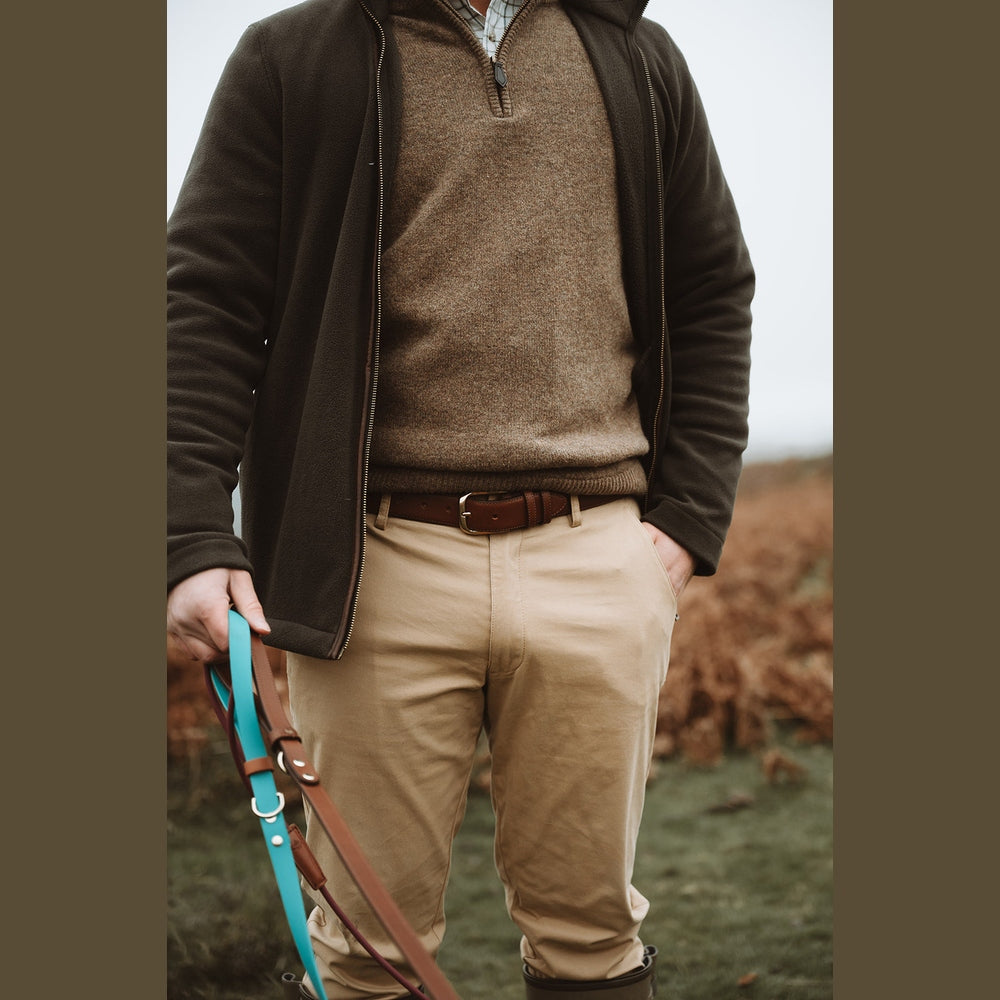 Handler holding turquoise Biothane dog leads, front detail