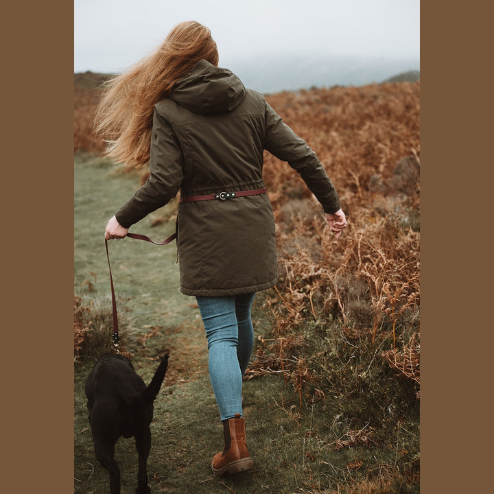 Biothane multi-way lead worn around the waist while walking a dog, rear view