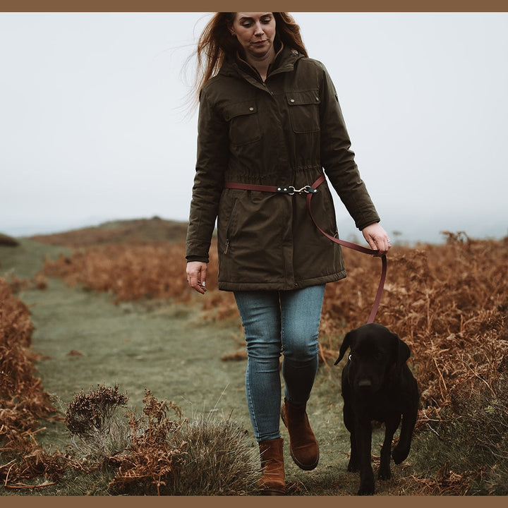 Handler walking a black Labrador with a waist-worn Biothane lead
