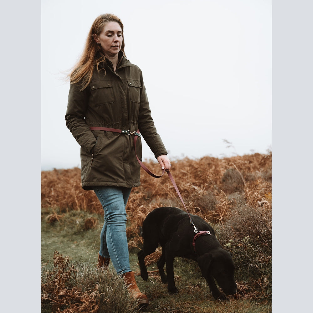 Handler with a black Labrador using a Biothane multi-way lead outdoors