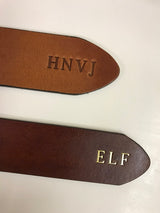Belt tips with plain debossed initials above and gold foil initials below