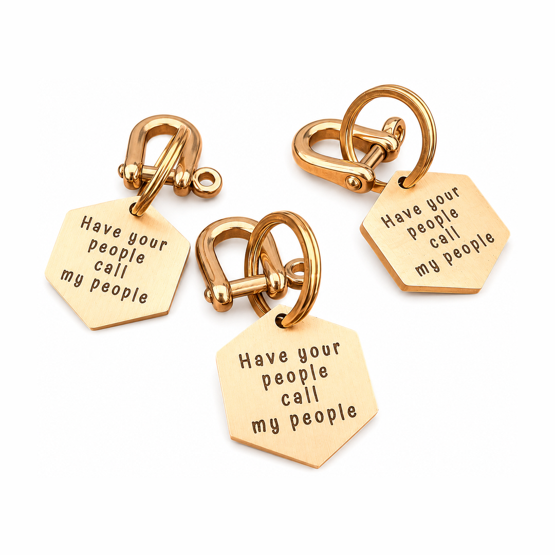 Three hexagonal brass dog tags with engraved lettering