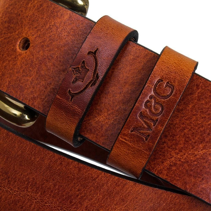 Close-up of chestnut Chester belt keepers with embossed initials