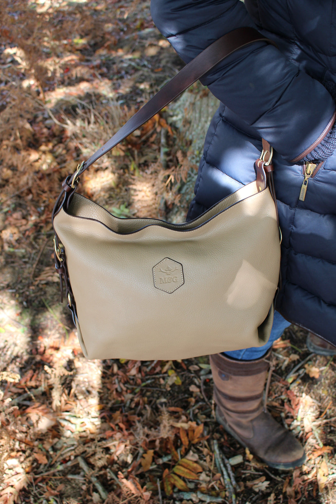 Neutral Clifton Tote carried beside a navy coat