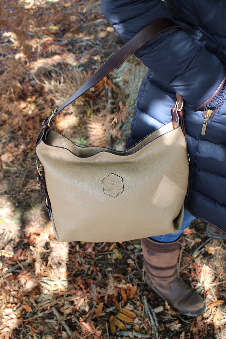 Neutral Clifton Tote carried beside a navy coat